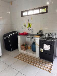 a kitchen with a stove and a sink at Casa praia do frances in Marechal Deodoro