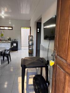 a living room with a table and a kitchen at Casa praia do frances in Marechal Deodoro