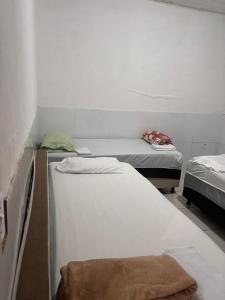 a room with two beds in a room at Casa praia do frances in Marechal Deodoro