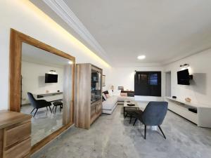 a living room with a couch and a table and chairs at Contemporary apartment, sea view in Lomé