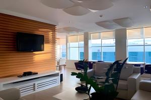 a conference room with a flat screen tv on a wall at Saint Moritz, bom gosto e estilo in Brasilia