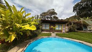 a small swimming pool in front of a house at Padua Finca Hotel in Chachagüí