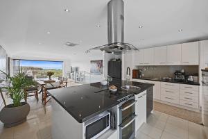 a kitchen with white cabinets and a counter top at Barbro Warrnambool in Warrnambool