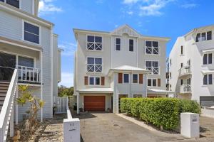 a row of white houses with a driveway at Barbro Warrnambool in Warrnambool