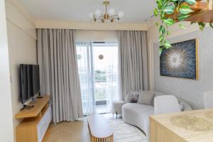 TV a/nebo společenská místnost v ubytování ADASHA Homes