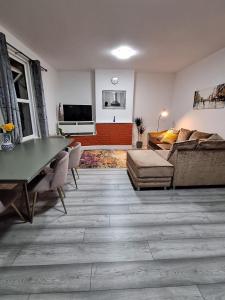 a living room with a couch and a table at home from home 2 bed flat in Kingston upon Thames