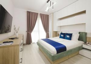 a hotel room with a large bed and a desk at Smart Stay Plaza in Bucharest