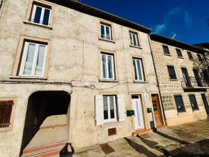 a large brick building with an open door at Le Maréchal Chic - Centre ville - Rive de Gier in Rive-de-Gier