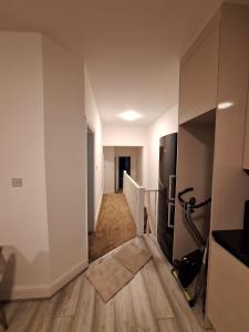 an empty room with a kitchen and a hallway at home from home 2 bed flat in Kingston upon Thames