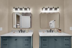 a bathroom with two sinks and two mirrors at Letson Loft Hotel in Bisbee +42 photos