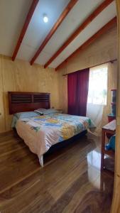 a bedroom with a large bed in a room at Cabaña Pulingue-Base Camp in Ancagual