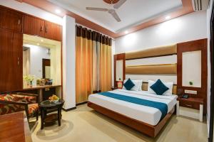 a bedroom with a large bed and a living room at Hotel Star Plaza - 1 Minute From New Delhi Railway Station & Connaught Place in New Delhi