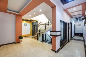 a hallway with orange walls and stairs in a house at Hotel Star Plaza - 1 Minute From New Delhi Railway Station & Connaught Place in New Delhi +20 photos