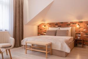 a bedroom with a large bed with a brick wall at Kazimierz Residence Apartments Parking - by Staymoovers in Krakow