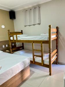 two bunk beds sitting in a room with at Parati - Hotel Pousada e Motel in Quatá +22 photos