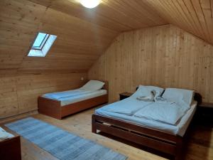 a room with two beds in a wooden cabin at Золотий Ключик in Vyshka