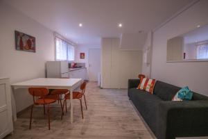 a living room with a couch and a table at Studio central 002B in Saint-Étienne