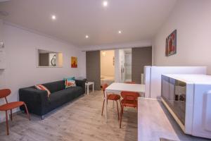 a living room with a couch and a table at Studio central 002B in Saint-Étienne