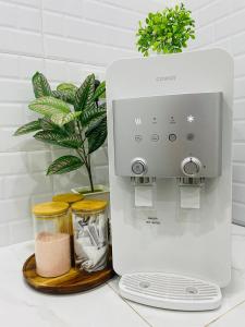 a mixer sitting on a counter next to a plant at Timeless Cottage KB in Kota Bharu