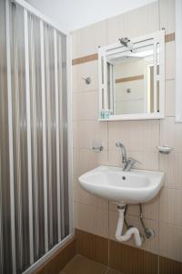 a bathroom with a sink and a mirror at Akrothalassia in Adamantas +105 photos