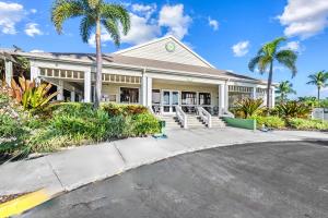 a house with palm trees in front of a street at Full Duplex on Longboat Key, Walk to the Gulf + Cedars East Club Access in Longboat Key