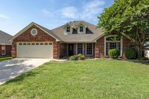 a brick house with a garage at Near UNT - Downtown Denton - Full Fenced Backyard in Denton