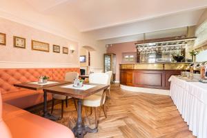 a restaurant with a table and a bar at Boutique Hotel Katerina in Znojmo