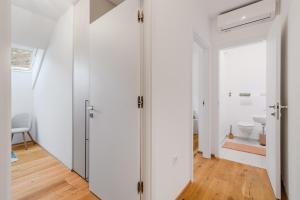 a room with white walls and a bathroom with a toilet at Family Apartment Bovec with Free Parking in Bovec +25 photos