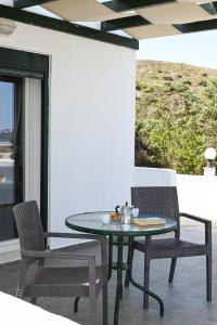 a table and chairs sitting on a patio at Akrothalassia in Adamantas