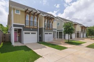 a row of houses with garages at Fenced Backyard - Walk to Old Town Lewisville in Lewisville