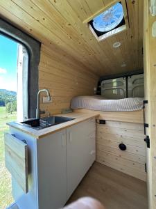 a kitchen in an rv with a sink and a bed at campers georgia in Kutaisi