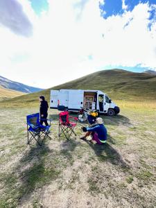 two people sitting in chairs in front of a trailer at campers georgia in Kutaisi