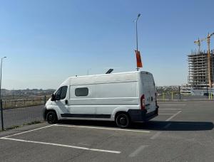 a white van parked in a parking lot at campers georgia in Kutaisi +1 photo