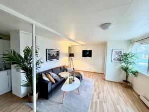 a living room with a couch and a table at Casa Troll in Tromsø