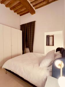 a bedroom with a white bed and a window at Apartment in the historic center of Perugia in Perugia +14 photos