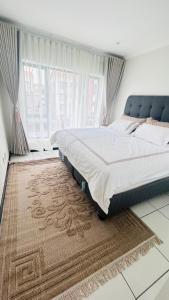 a bedroom with a large bed and a large window at Luxury Fourways Apartment, Pool, Gym and 24hr Security - Ventura Estate in Sandton