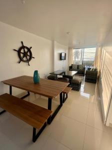 a living room with a wooden table and a boat on the wall at House in front of Pisco-Paracas beach in Pisco