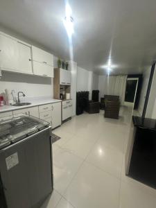 a kitchen with white cabinets and a stove top oven at House in front of Pisco-Paracas beach in Pisco