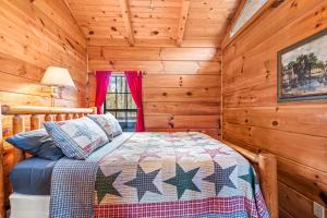 a bedroom with a bed in a log cabin at Sleepy Creek - Hot Tub, Pet Friendly, Creekside, Grill, Wifi, Fire Pit, Deck, Screen Porch, Family Friendly, Fishing, View, Games in Berkeley Springs