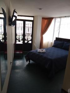 Ένα ή περισσότερα κρεβάτια σε δωμάτιο στο Hotel Inti Raymi