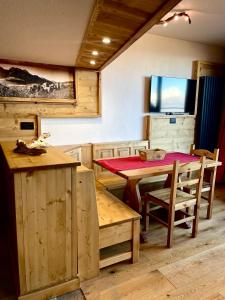 a dining room with a wooden table and chairs at White Relax in Pila +9 photos