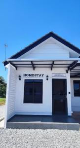 a white building with the words homesteadery on it at Homestay Dataran Tikam Batu in Sungai Petani