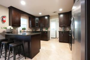 a kitchen with wooden cabinets and a refrigerator at Destination #06 in Anaheim