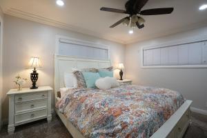 a bedroom with a bed and a ceiling fan at Destination #06 in Anaheim +28 photos