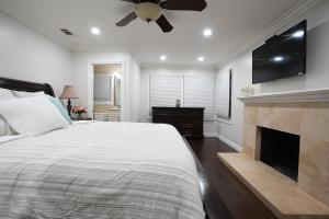 a bedroom with a bed with a fireplace and a flat screen tv at Destination #06 in Anaheim