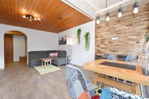 a living room with a couch and a table at Rundblick 2 Gartenwohnung in Tschagguns