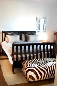 Postel nebo postele na pokoji v ubytování Tradewinds Guest House