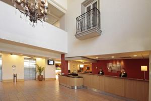 a lobby of a hospital with two people sitting at a counter at Holiday Inn Express - Monterrey - Tecnologico by IHG in Monterrey +99 photos