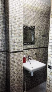 a bathroom with a white sink and a mirror at Apartment in city center in Daugavpils