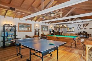 a living room with a pool table and ping pong balls at Harmels on the Taylor in Almont